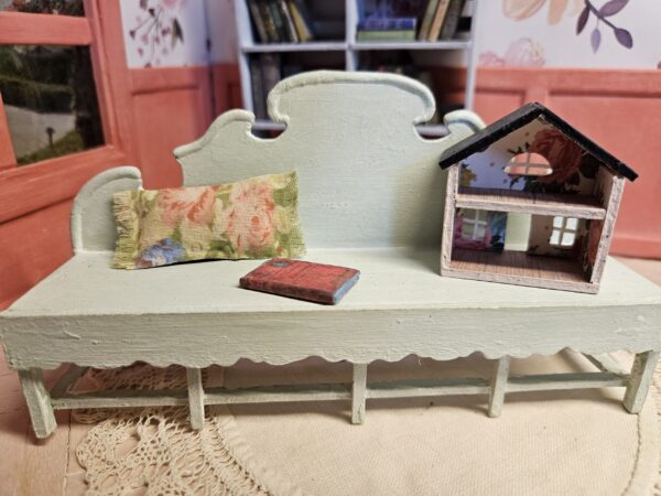 Ornate shabby chic miniature bench "Janice", with a pillow, "Dolly's Dollhouse", and an antique miniature book, 12th scale